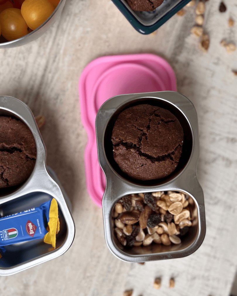 Snack tins packed with chocolate muffins, trail mix and cheese cubes