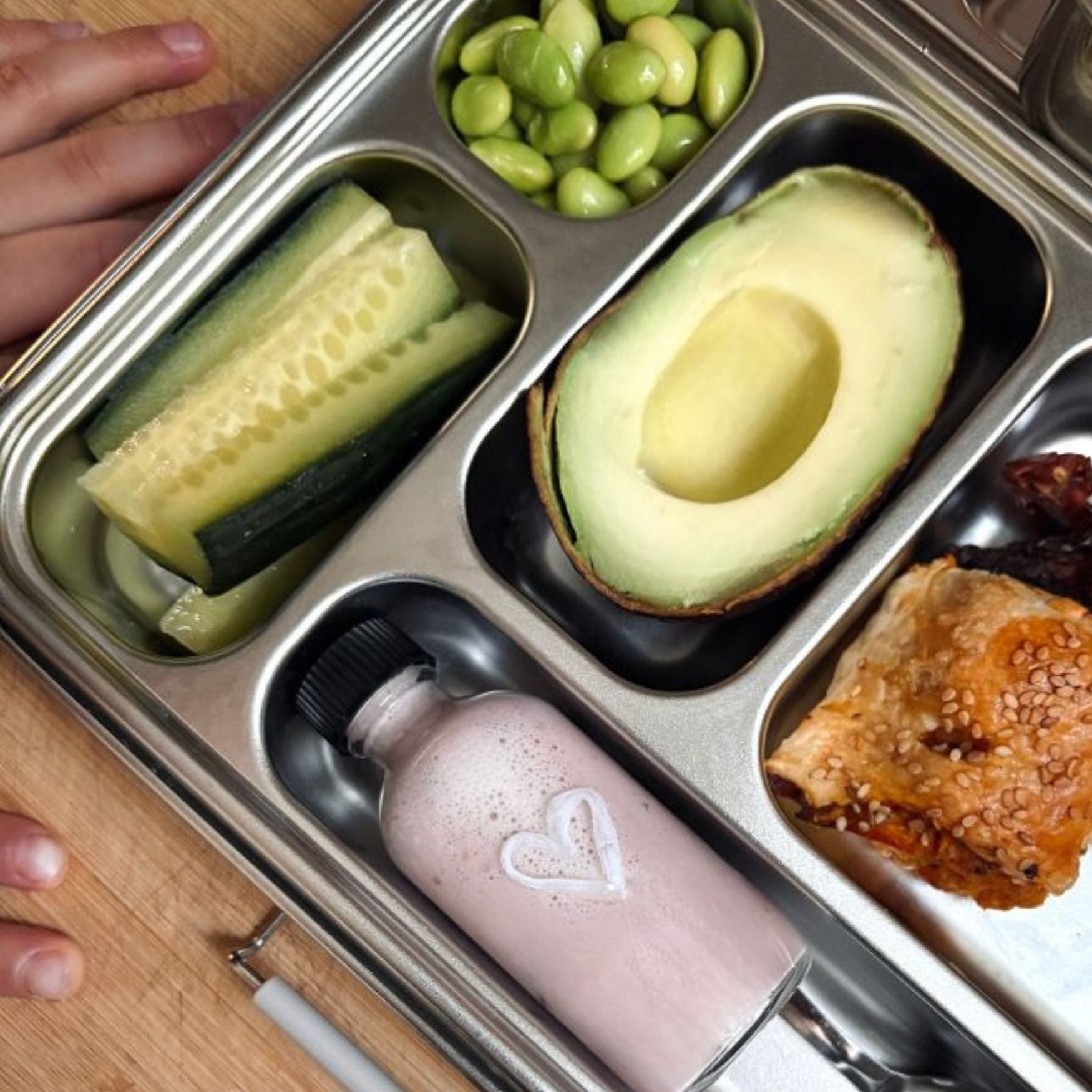 A real lunchbox: cucumber, edamame, avocado, smoothie, salmon