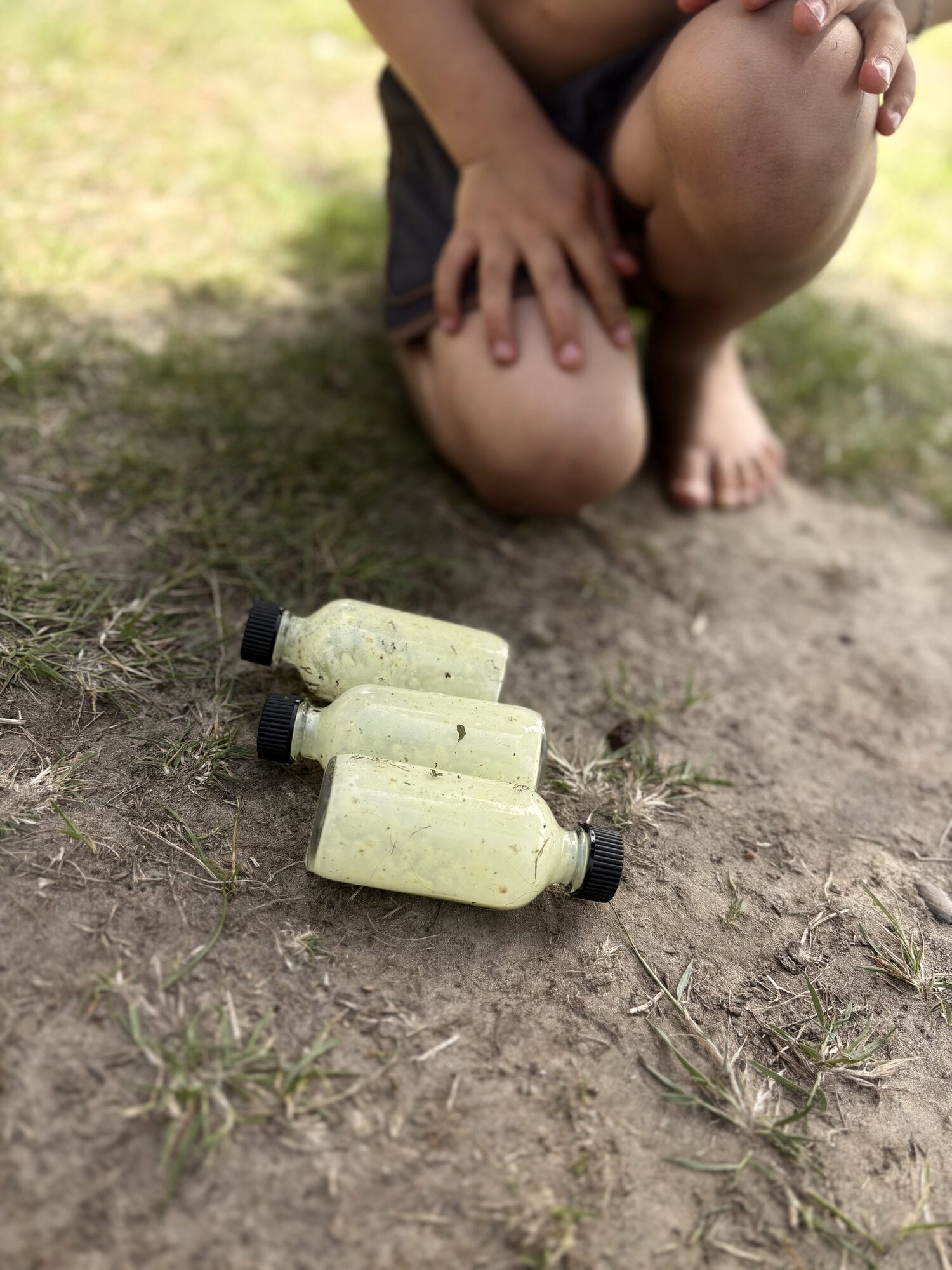 Kid with smoothie bottles