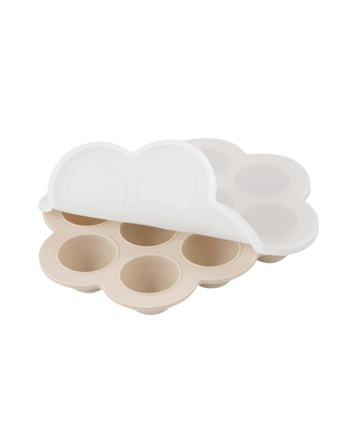 Beige cloud-shaped silicone freezer tray with seven round wells and a white lid